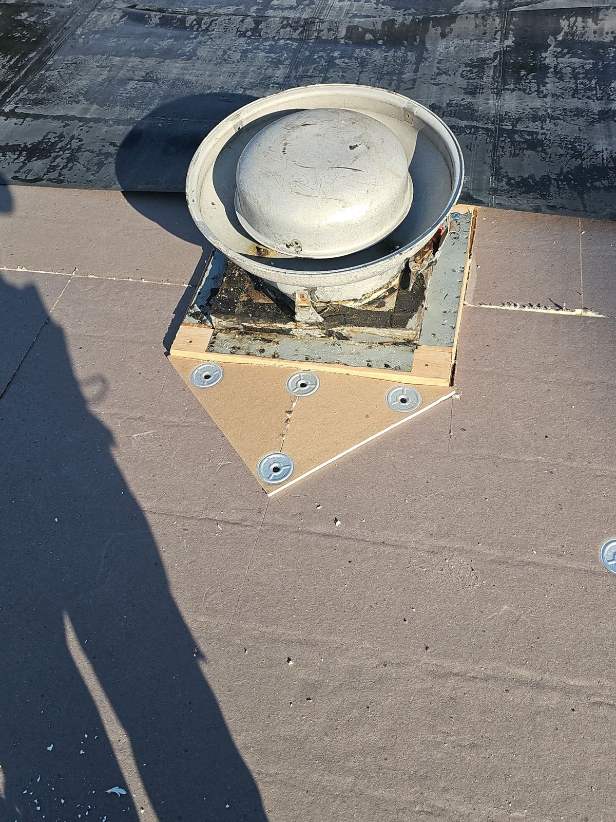 Roof vent curb framed and flashed on a new flat roof